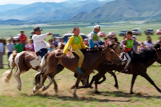 This was a one of the highlights of my trip - seeing the young boys racing in the final to the local Naadam festival in Ikh-Uul. 
I love the look of terror on the boy in front whose horse is slowing down, and the look of confidence on the boy in yellow who eventually won the race. Though only 8 years old, these boys rode from over the horizon without saddles, shoes or any apparent sign of fear. 