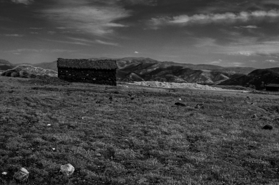 A wattle and daub house, at the top of hill. This is the final destination for the people who were at the market, is where their Sunday ends.