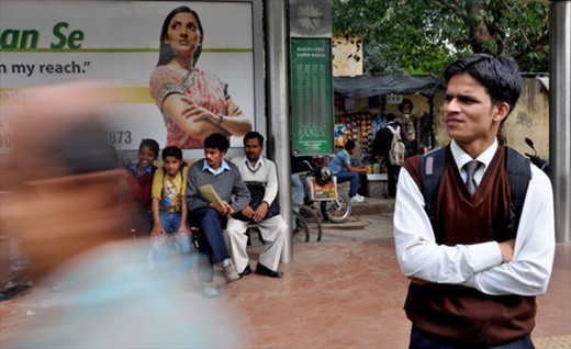 A young professional waiting for the bus at a stand in Shankar Market,New Delhi.