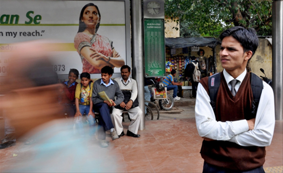 A young professional waiting for the bus at a stand in Shankar Market,New Delhi.
