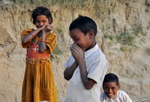 A boy with his sister both working at a brick field in northern state of India.