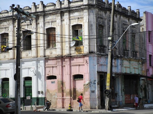 A lone flag flutters in downtown Fortaleza while a few blocks away crowds surge among the towering, modern condos and beachfront restaurants where officially sanctioned FIFA World Cup events take place.