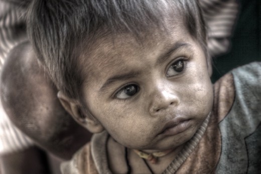 It is a picture of a little boy who does not even know what the outside world is all about. Yet he is facing all the hardships right from his childhood. His face full of innocence attracted me.