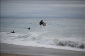 A skimboarder jumps up from a wave as friends watch: by ronvaliente, Views[330]