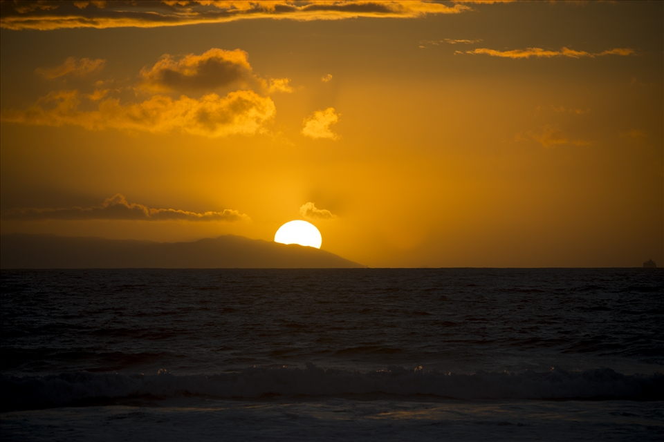 The sun sets behind Santa Catalina Island viewable in Laguna Beach