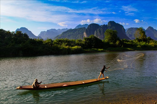 «Local fishermen in Vang Vieng, Laos»
Vang Vieng, Laos, December 2012. In an amazing scenery, local fishermen try to catch some fish in Nam Song River. This river is the heart of Vang Vieng and many locals depend on it. It's a beautiful and peaceful town with the serenety of the mountains as a background.
