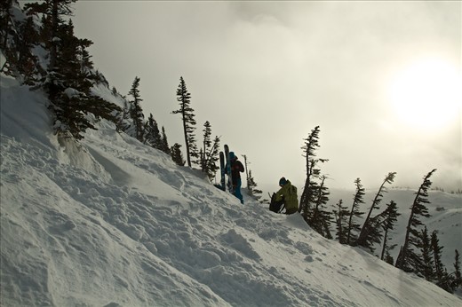 After hours of travel uphill and hard work the skiers prepare for the descent. 