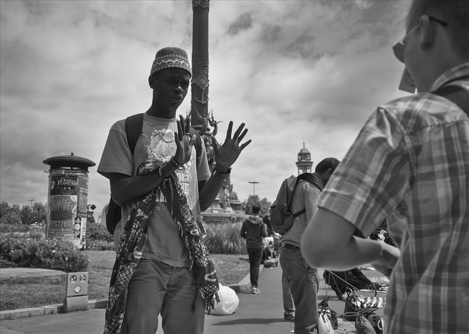A street vendor asking his price for the sunglasses