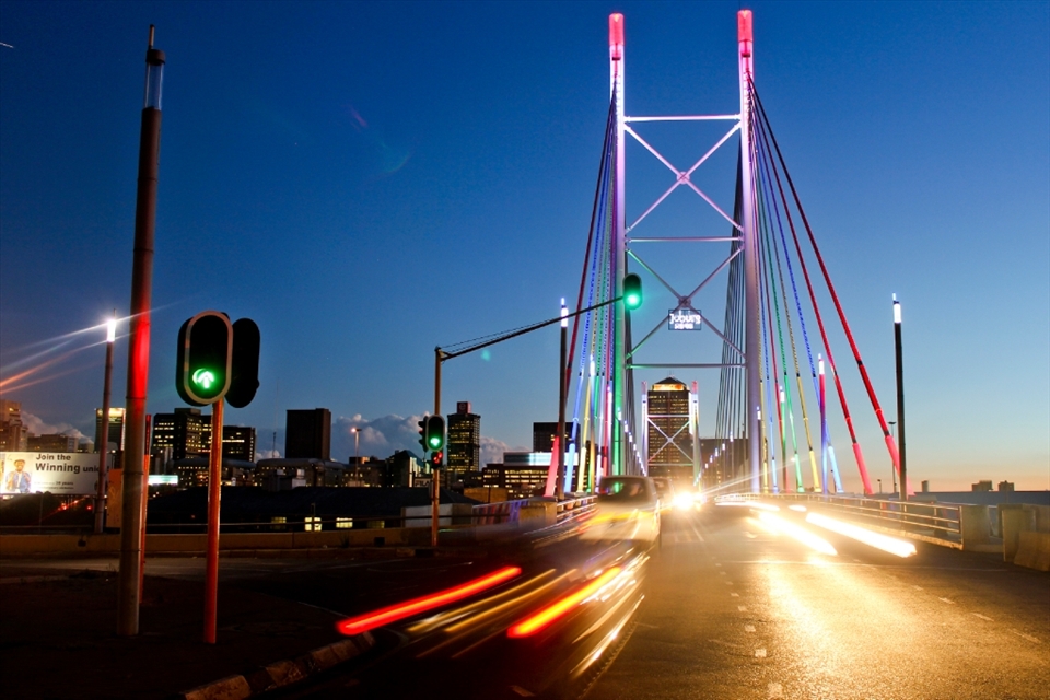 The Nelson Mandela Bridge in the CBD of Johannesburg. The bridge spans 250m and boasts the rainbow-coloured lights of our South African flag at night, lighting up the city and the traffic of taxis and travellers.© Robynne Peatfield 2012