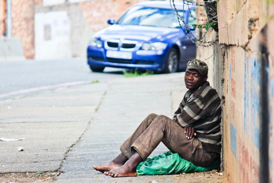 Maphikelela allowed me to photograph him while he rested on the streets of Johannesburg. He is homeless and finds a place to sleep where he can while looking for a job. The BMW parked near him is a tangible symbol of the inequality found in Johannesburg and South Africa. © Robynne Peatfield 2012