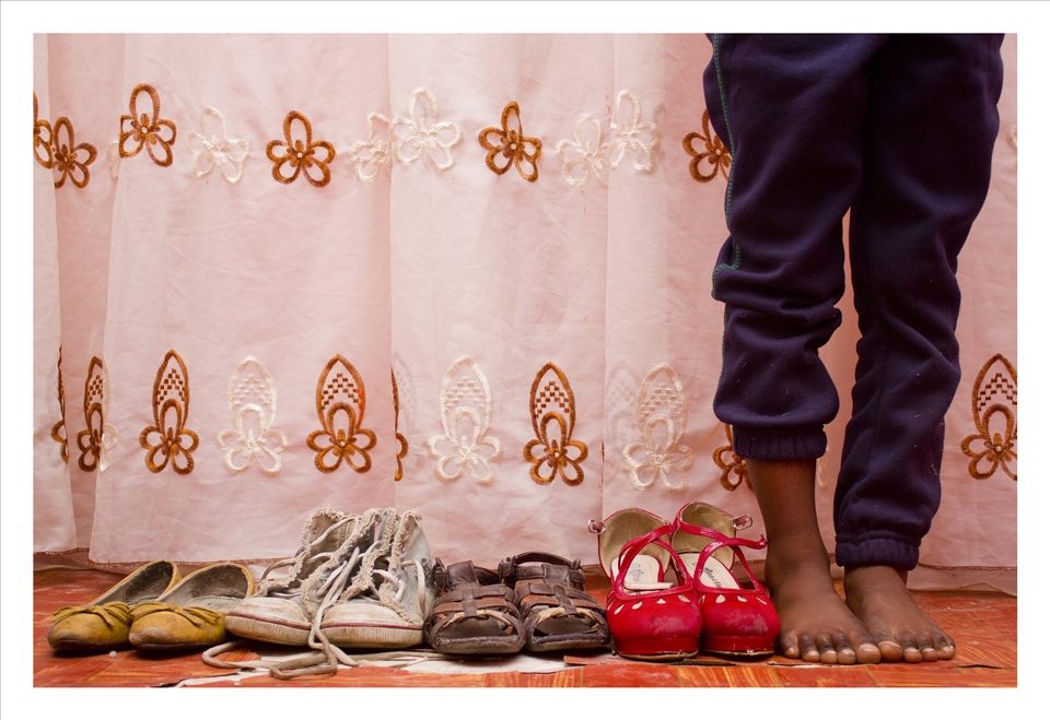 A portrait of Siya Dlakwe and her shoes in Alexandria, South Africa. 