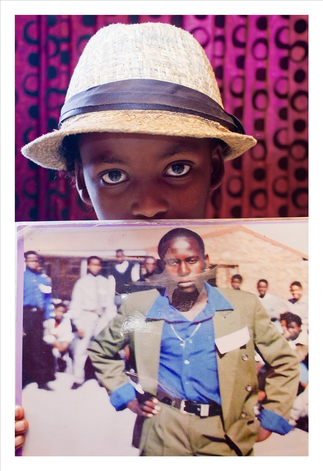 A portrait of Siya with a photo of her father, whom she doesn't know