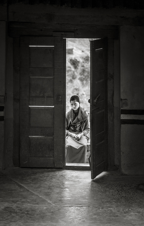 As open and welcoming the older monks are, the younger monks are often more conservative & shy. Older monks have probably been more exposed to the concept of visitors taking photographs, however younger monks that are still adjusting to it often have a little difficulty which is usually very evident from their facial expressions and body language. This young monk was particularly shy and hid his face every time I tried to photograph him, eventually I happened to catch him at the most unsuspecting moment while he was observing the kind of photographs I was taking. 