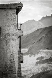 One of the most stunning aspects of Ladakh's many monasteries is their location. Nestled in the mountains and the foothills of the Himalayas, these monasteries offer some of the most breath taking views that one can only imagine or see in postcards. The calmness and serenity of these monasteries and the surrounding mountains is something that monks definitely derive from in order to maintain a sense of peace within them. Here we see a young monk sitting atop a balcony after completing his prayers.: by rssarma, Views[500]