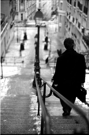 A man makes his way through his city. 