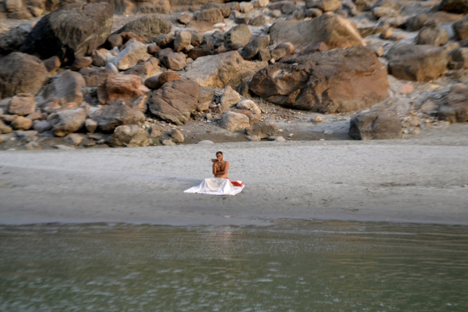 Enriching Revival -A Panditji reading his daily 'paath'(religious lesson) in the evening on the bank of Ganges