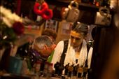 A reflection of the owners working away behind the small bar, surrounded by the various knick-knacks that hang off the pub's walls. I never did find out where the red fluffy handcuffs came from.: by russ_photo, Views[289]