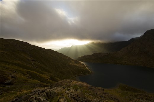 The money shot! After 3 days and nights of challenging conditions, I finally managed to witness the sun breaking through the 

clouds over the mountains of Snowdonia. It was worth every minute of discomfort.