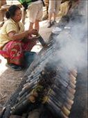 Woman tending fire for cooking sticky rice (in bamboo). So tasty!: by russc_01, Views[412]