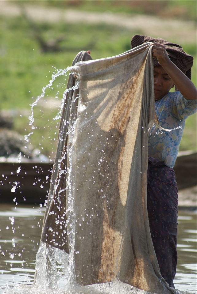 Today is laundry day for this Burmese woman who washes her family’s clothing along the banks of the Irrawaddy River.