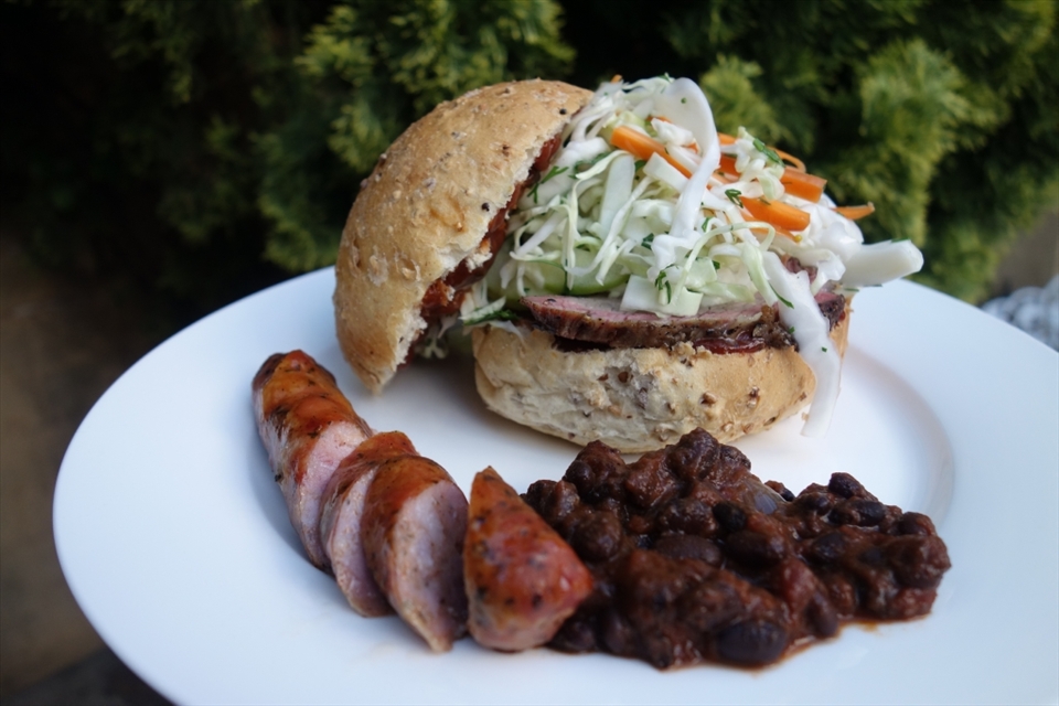 The complete meal (and trip down memory lane). Brisket in a bun with slaw and espresso barbecue sauce, cowboy beans and smoked sausage. 