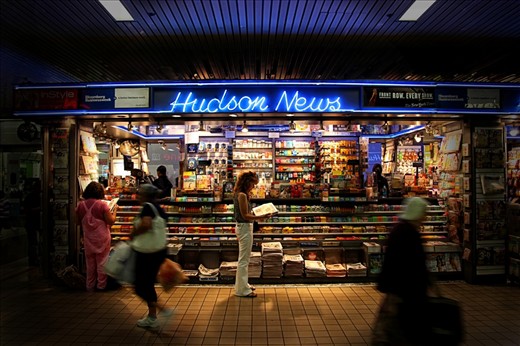 Hudson News Stand - A lady takes her time from the daily grind to catch the daily news/events.