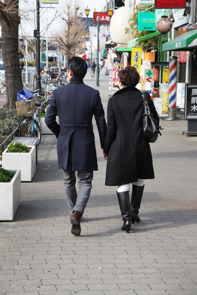 A guy and his mother strolling casually on a street in Osaka