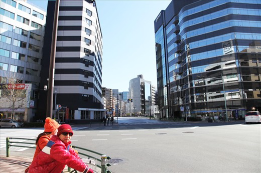 Tokyo bikers passing by a quiet block in a Sunday morning