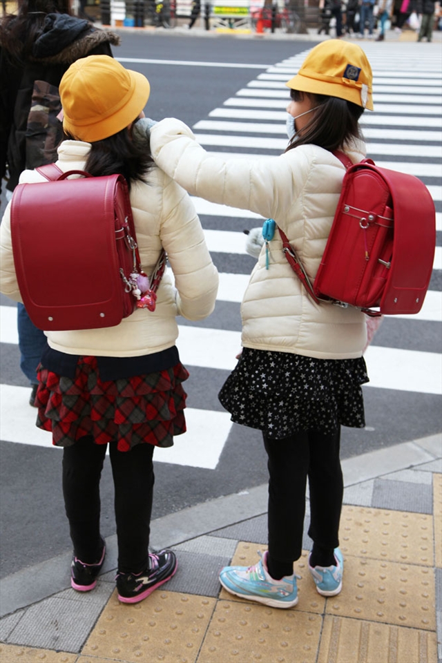 Elementary school girls helping each other
