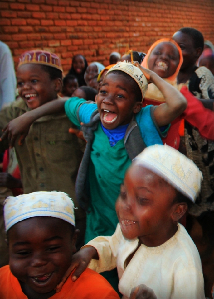 After the children finished at Mosque they saw us passing by. Before we knew it, hundreds were chasing after us. I caught this young boy in the moment of excitement. 