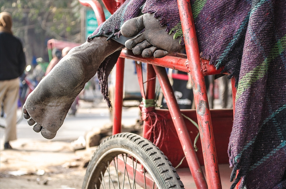 This picture was taken on the streets of Chandni Chowk market, is one of the oldest and busiest markets in Old Delhi. Cycle rickshaw drivers who does not have home / shelters use to sleep on their rickshaw (also known as pedicab) on the middle of the road.