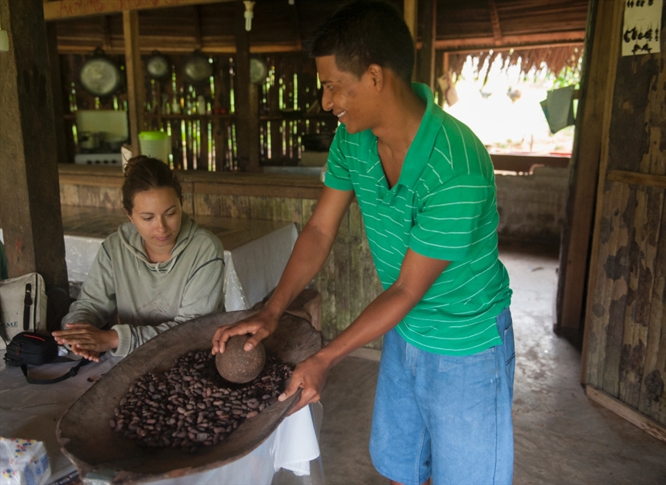 We are shown by our guide Eric, how they grind cocoa seeds to make chocolate.