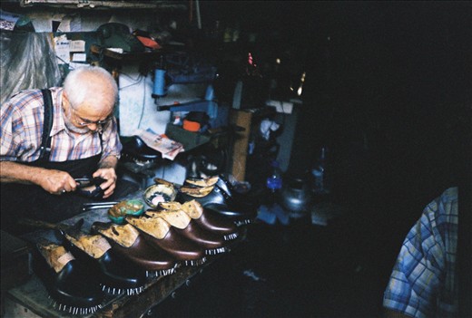 A shoesmaker I saw working while passing in front of his shop.