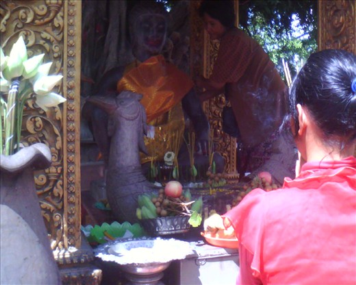 Such a devotion on a Buddha statue in the town of Siem Reap, Cambodia. 
