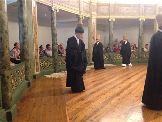 The beginning of the Sema ceremony of the whirling dervishes. This man is the revered master.