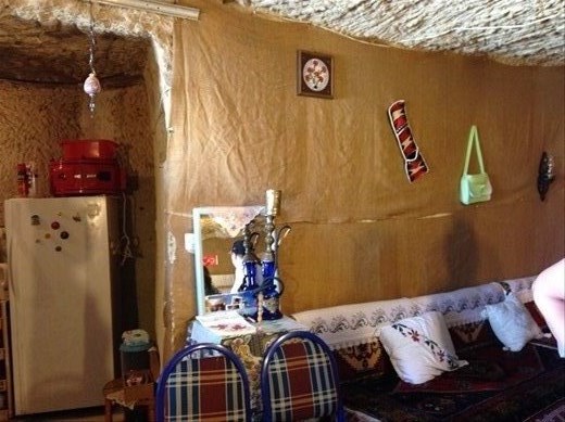 A cave home used currently by a 5th generation family. This large room &  a kitchen.