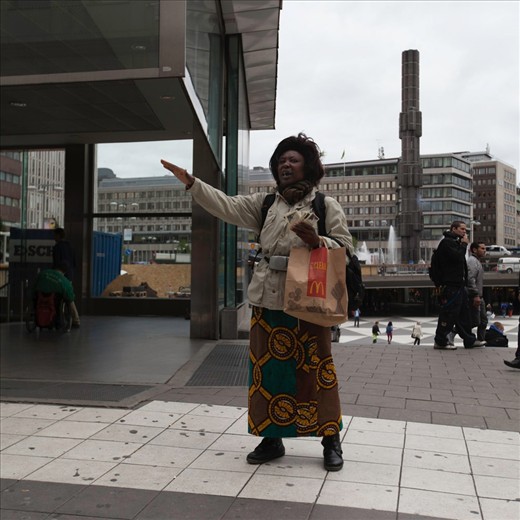 A woman preaches about the oncoming apocalypse if we don't change our ways in Stockholm, Sweden. Interestingly enough holding a fastfood bag. We have the freedom to say what we want. 