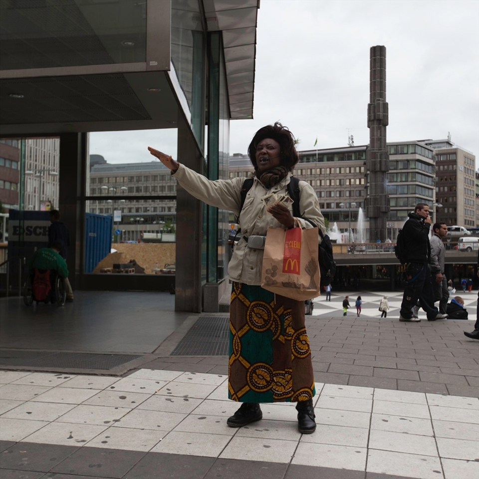 A woman preaches about the oncoming apocalypse if we don't change our ways in Stockholm, Sweden. Interestingly enough holding a fastfood bag. We have the freedom to say what we want. 