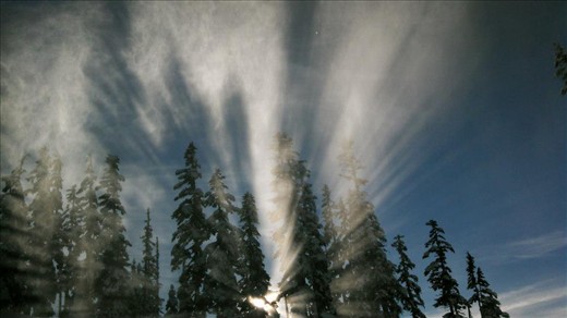Snow maker on the slopes making some magic through the morning sun.