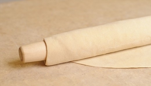 On a floured table roll the dough in a fairly thin layer .