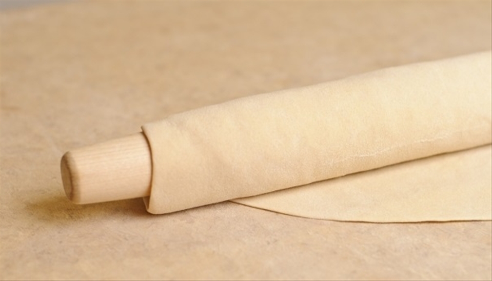 On a floured table roll the dough in a fairly thin layer .