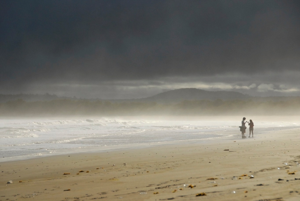 The jellyfish scattered beach is a popular hangout for the community of Puerto Villamil, the largest town on Isla Isabela.  Many people gather here daily to surf, explore the sea-life, and enjoy the laidback lifestyle.  In the background, Cerro Azul, an active volcano, peaks through the mist.
