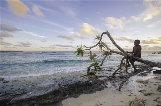 Pikinini from Pango plays on the beach during sunset