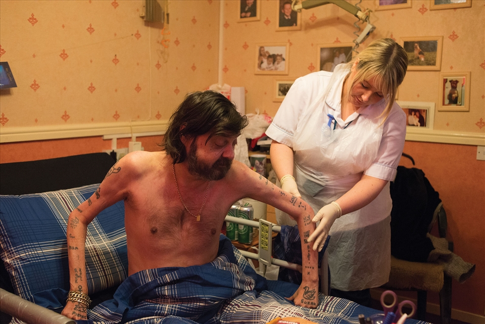 Natalie checks a bedbound mans' pressure sores.