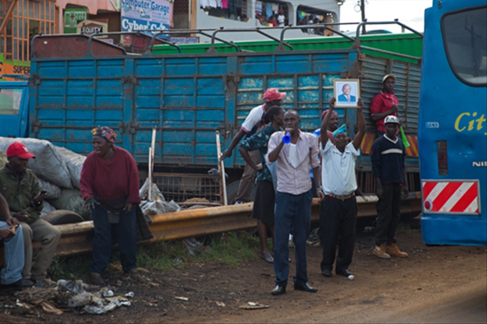A group of Kenyans celebrate after the Supreme Court of Kenya ruled that Uhuru Kenyatta (pictured in frame) was indeed the elected president of Kenya. He had previously been accused, by a number of different groups. that he had rigged the 2013 presidential election in his favour.
