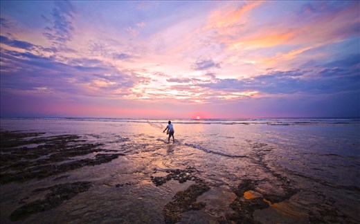 Local fisherman throwing a net on sunset. 