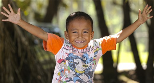 A young local Mandiri Boy embraces the camera