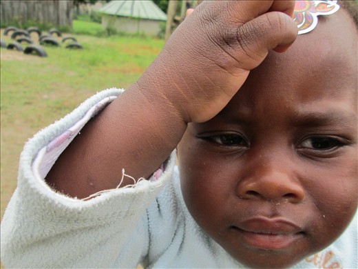 Zulu boy showing off the sticker on his forehead.