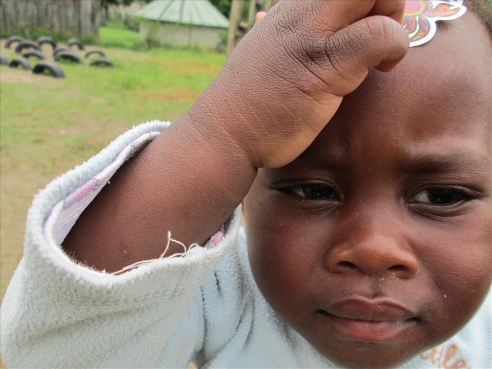 Zulu boy showing off the sticker on his forehead.