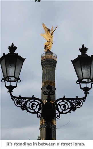 It's standing in between a street lamp